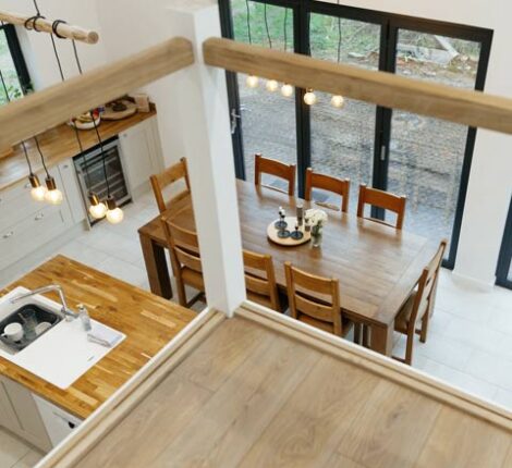 Featured image of barn conversion interior looking down from the mezzanine across an open plan kitchen diner.