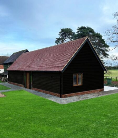 Annexe annexe exterior featuring charred wood cladding and clay tile roof.